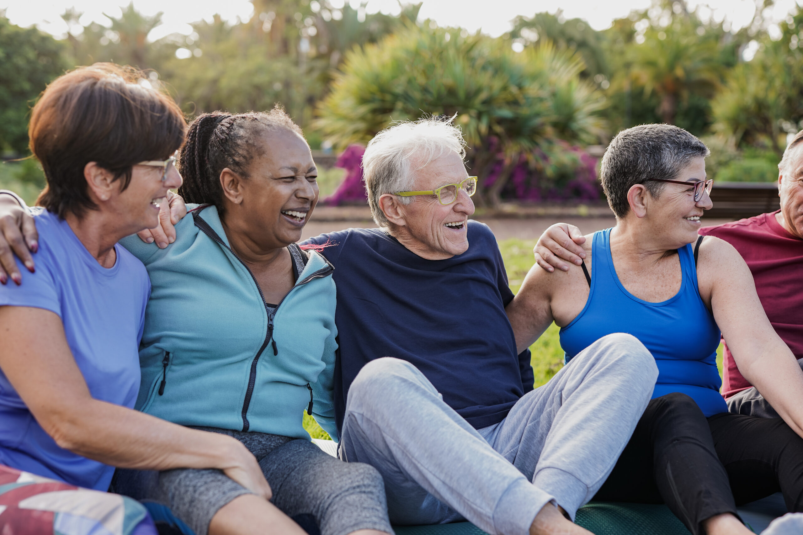 Senior friends having fun together at park after yoga exercise class